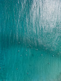 A scenic view of surfers riding waves in Bali.