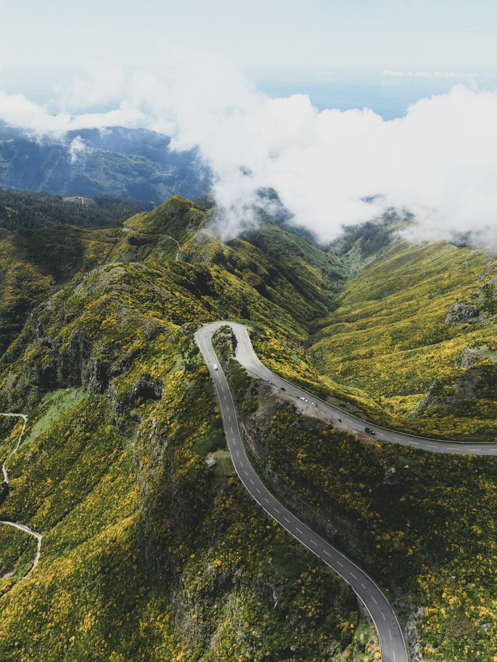 an aerial view of a winding road in the mountains