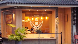 Cozy interior of Vamilia restaurant with warm lighting and rustic-modern Portuguese decor.
