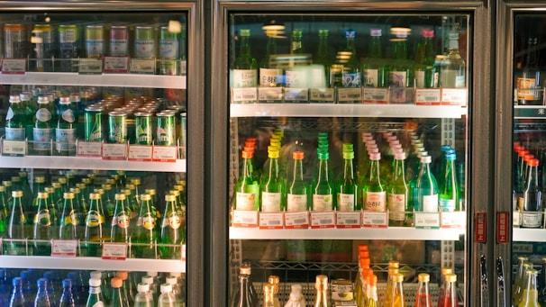 a refrigerator filled with lots of bottles of alcohol