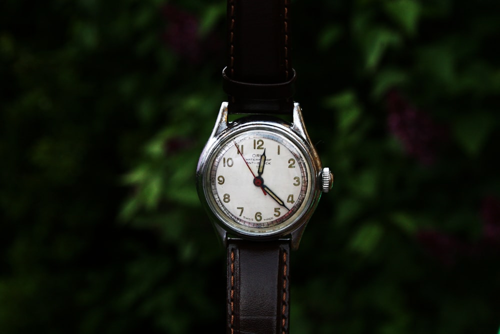 a close up of a watch on a leather strap