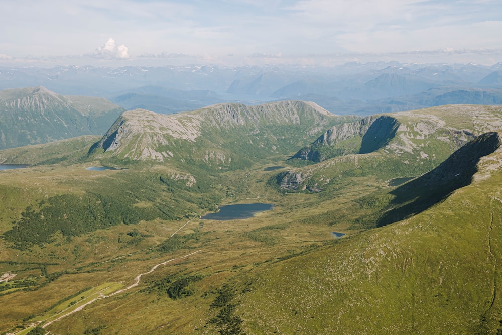 an aerial view of a valley with mountains in the background