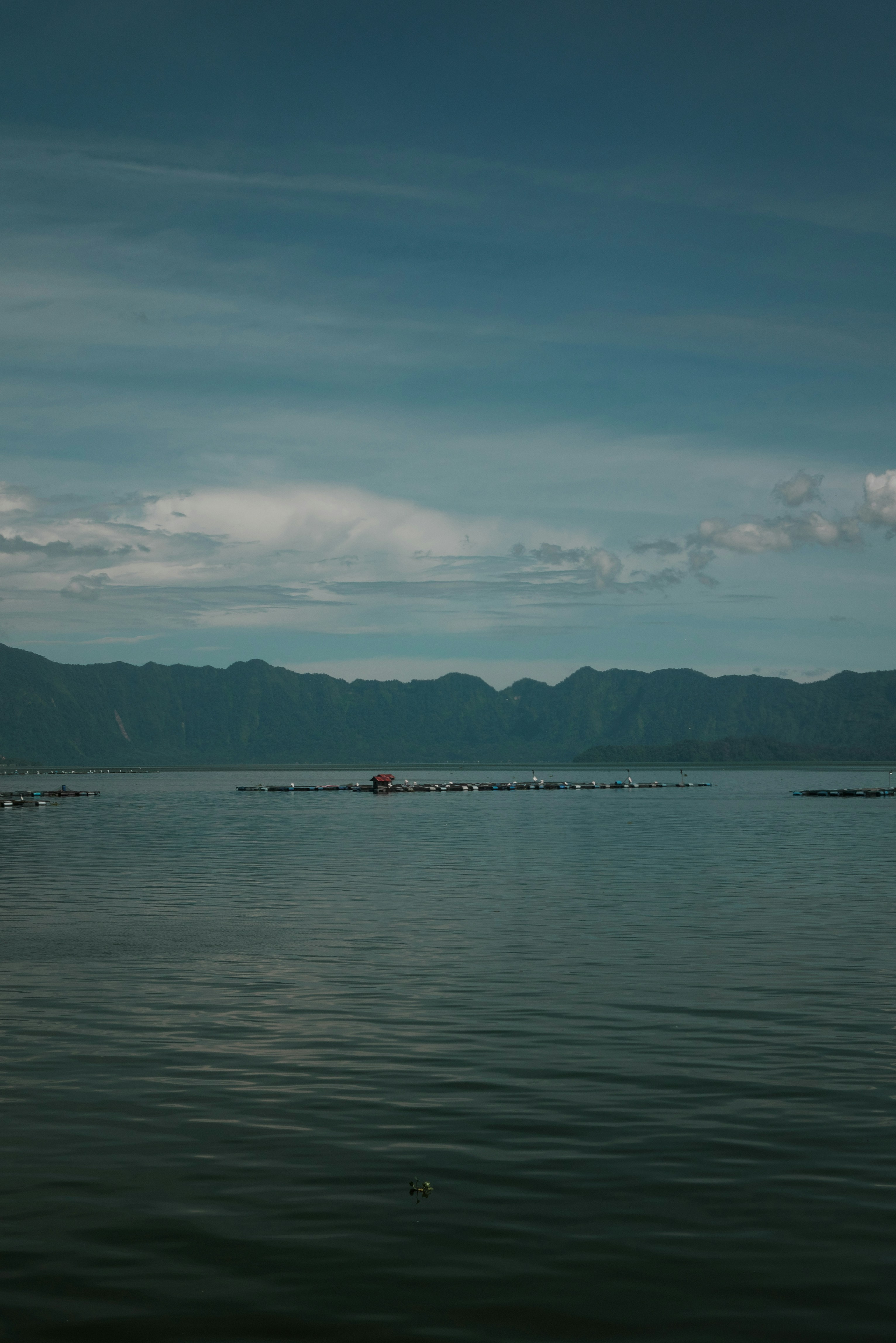 a body of water with mountains in the background