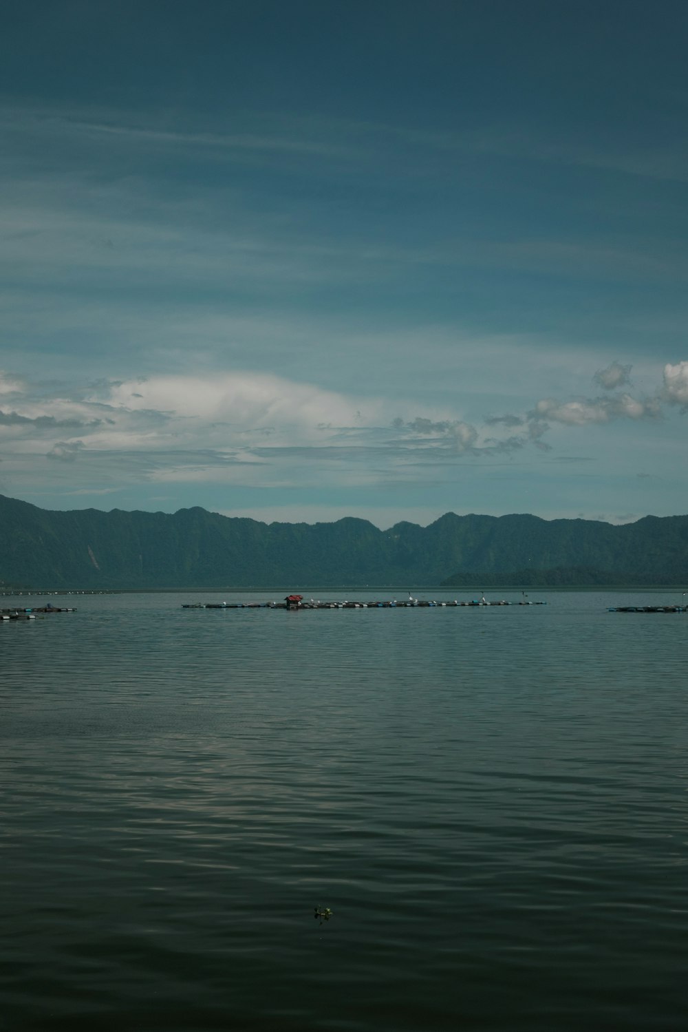 a body of water with mountains in the background