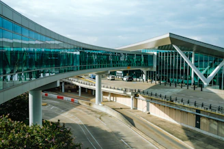 a curved walkway leads to an airport terminal