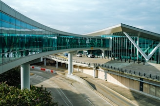 a curved walkway leads to an airport terminal