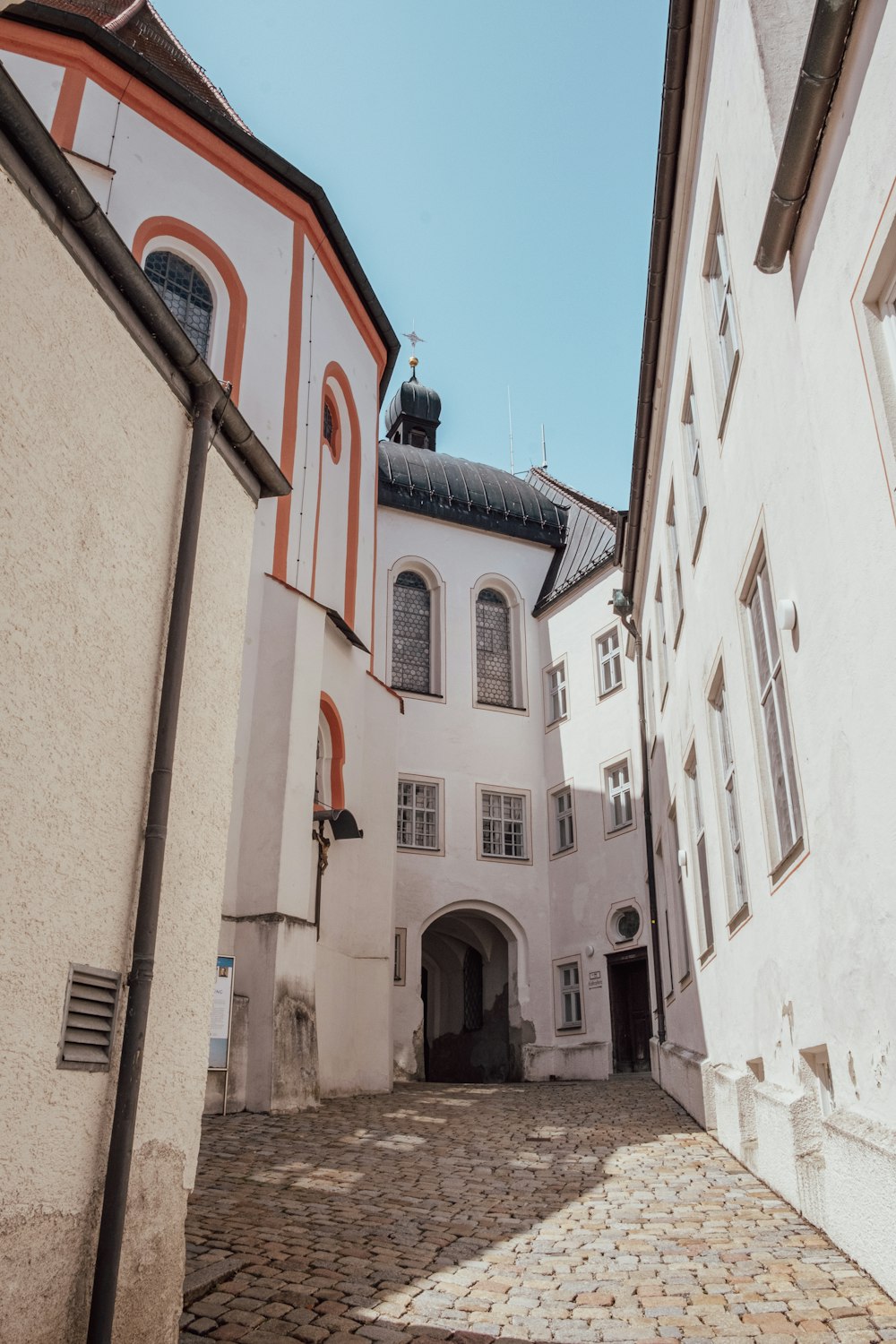 a white building with a red and white stripe on it