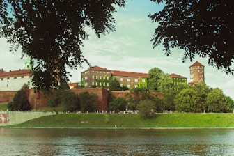 a large building sitting on top of a lush green hillside