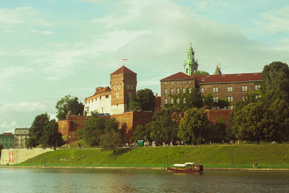 a large building sitting on top of a lush green hillside