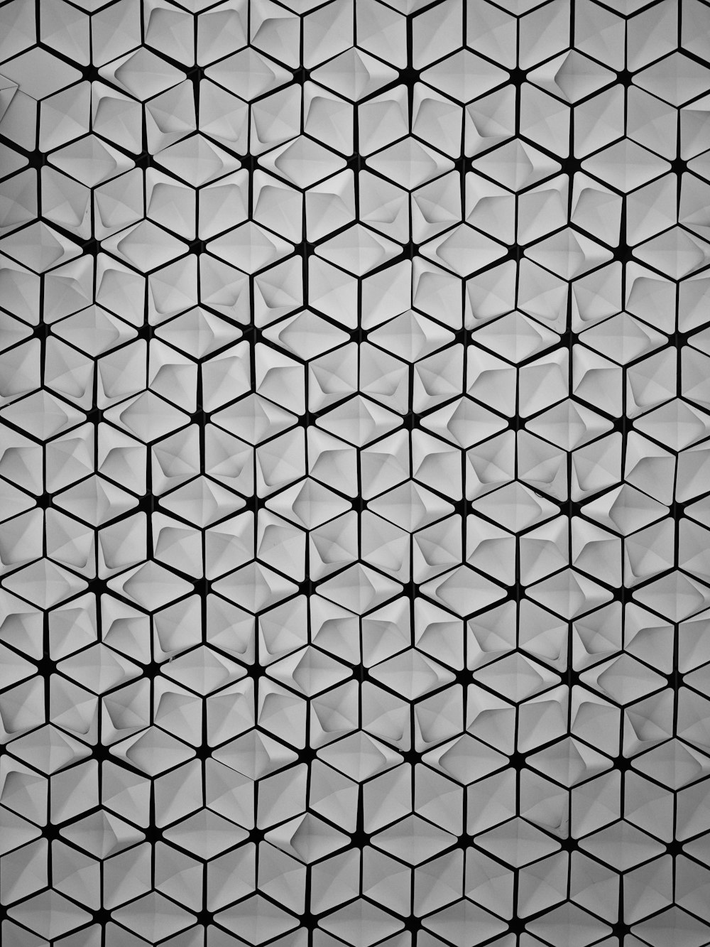 a black and white photo of a pattern of cubes