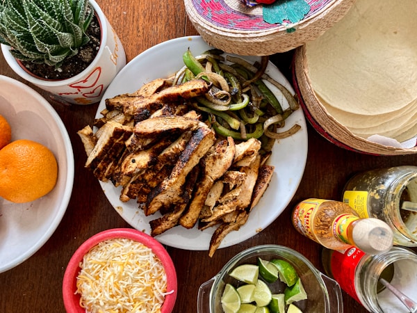 A wooden table topped with plates of food