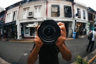 Close-up of a professional photographer capturing a local business storefront.