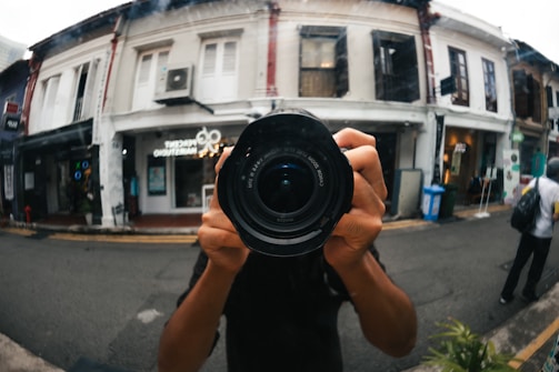 Close-up of a professional photographer capturing a local business storefront.