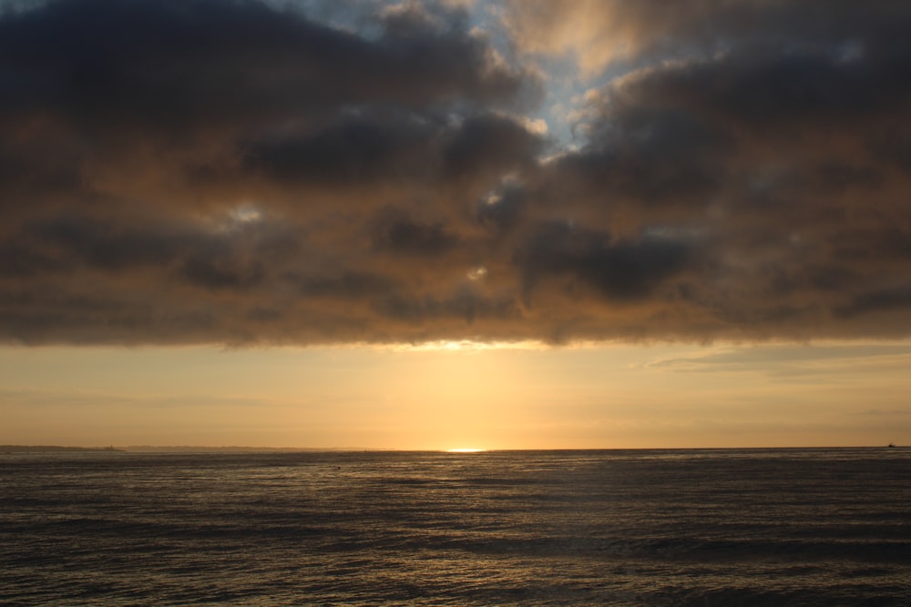 a large body of water under a cloudy sky