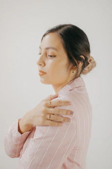 A serene image of someone gently applying a Lifewave patch to their shoulder.
