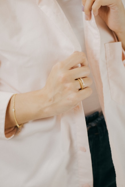 Beige tailored blazer paired with delicate gold accessories under soft natural light