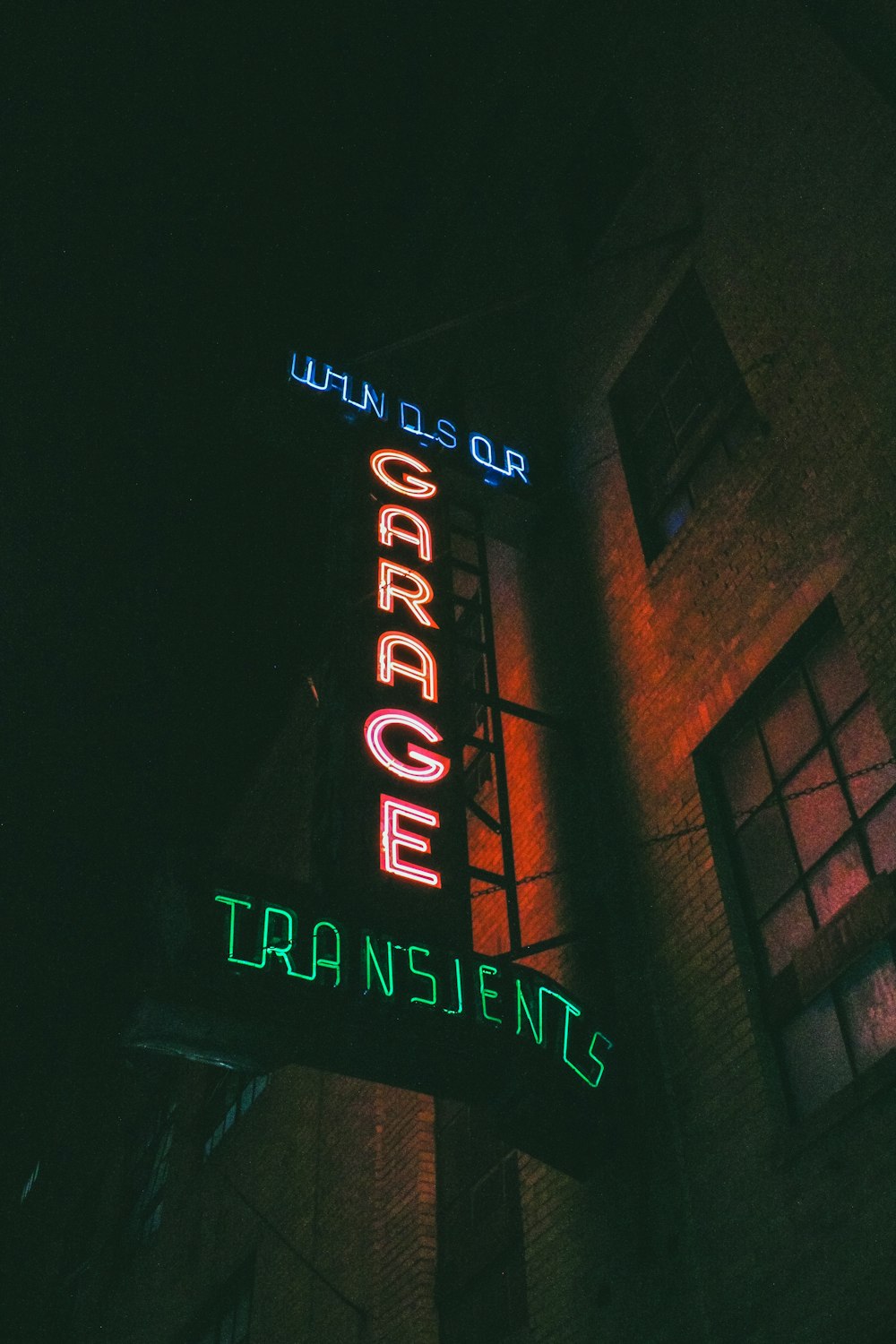 a neon sign on the side of a building