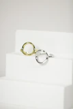Simple, sleek Korean rings arranged on a marble surface.