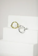 Simple, sleek Korean rings arranged on a marble surface.