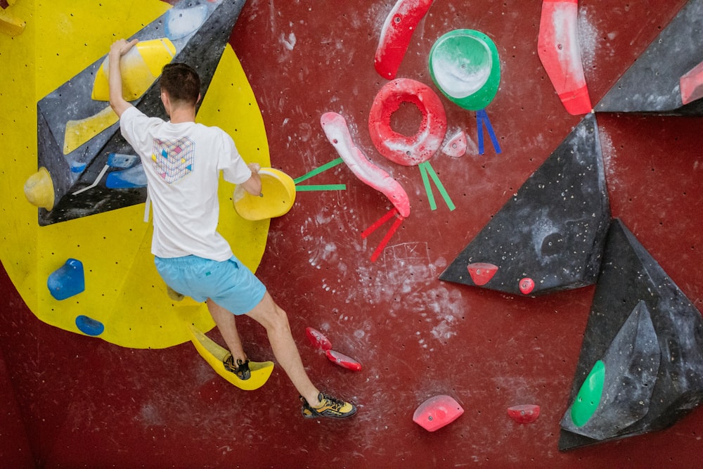 a man is climbing on a climbing wall