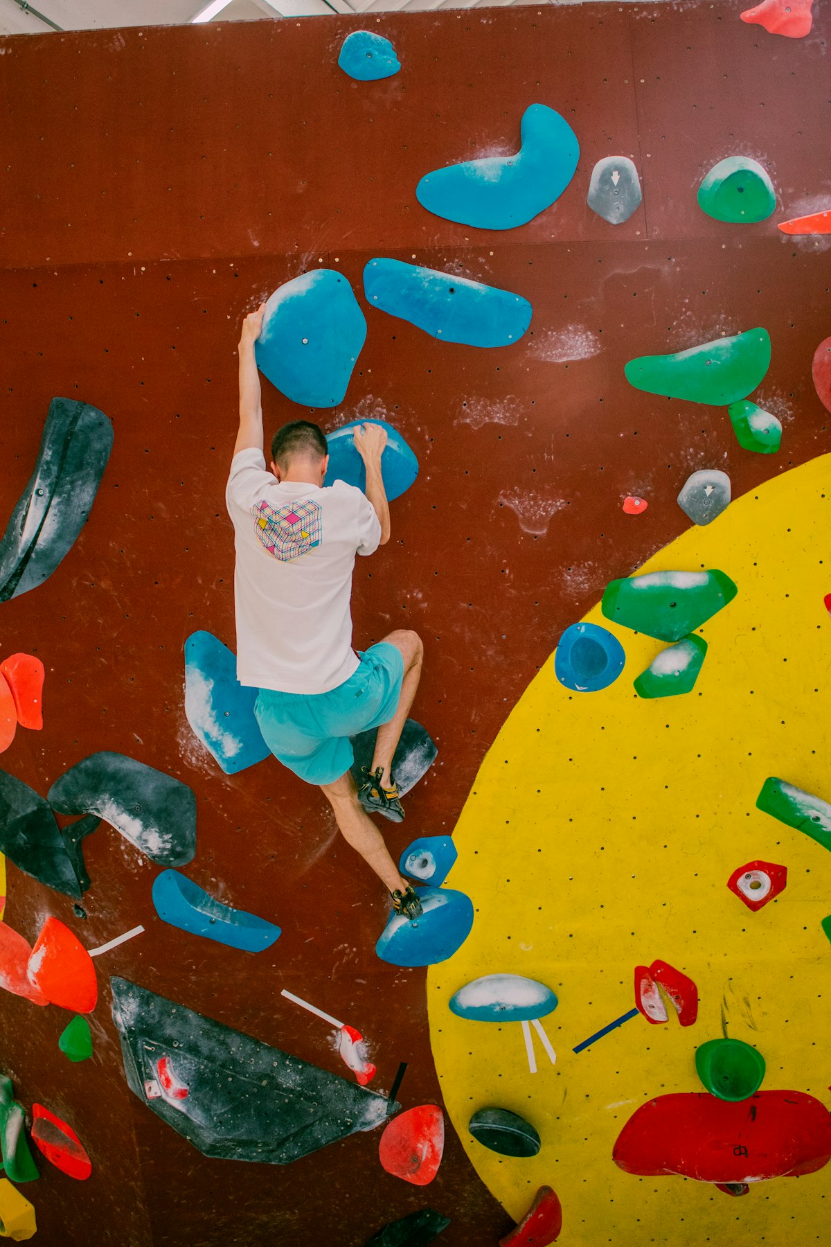 Indoor climbing gym wall with various holds