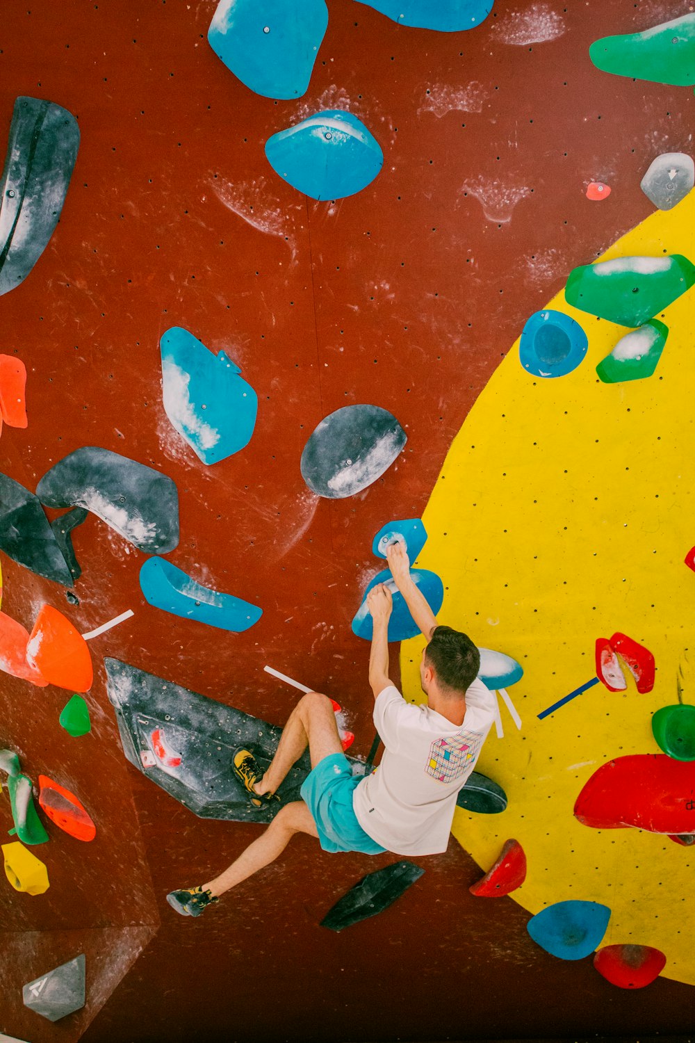 a man is climbing on a climbing wall