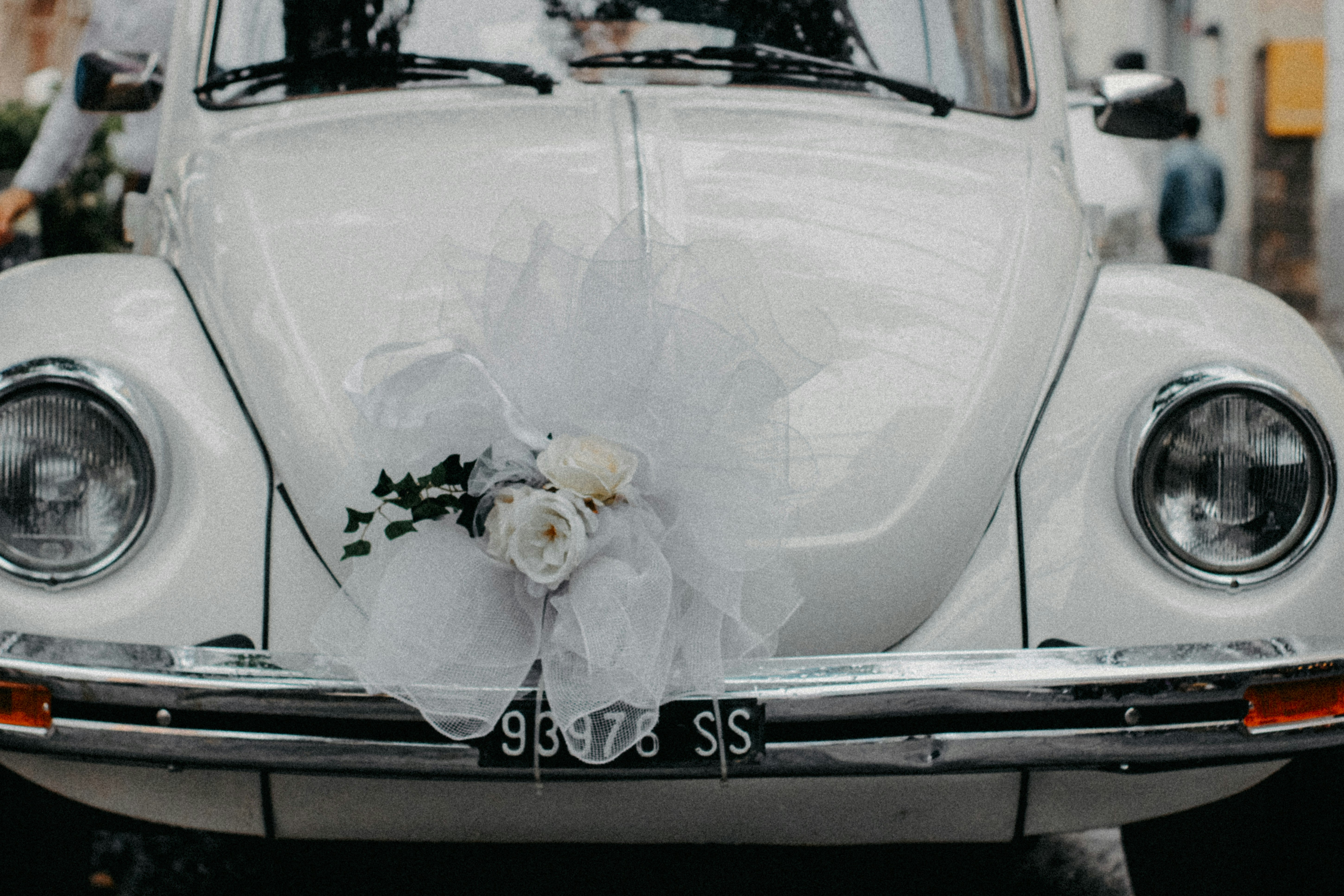 a white car with a bouquet of flowers on the front