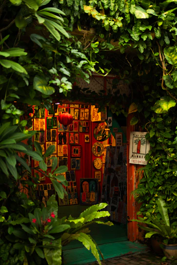 A warmly lit gallery space filled with colorful paintings and lively music performers.