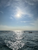 A serene water scene with sunlight reflecting off gentle waves.