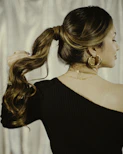 a woman with long hair in a ponytail