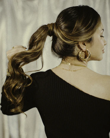 a woman with long hair in a ponytail