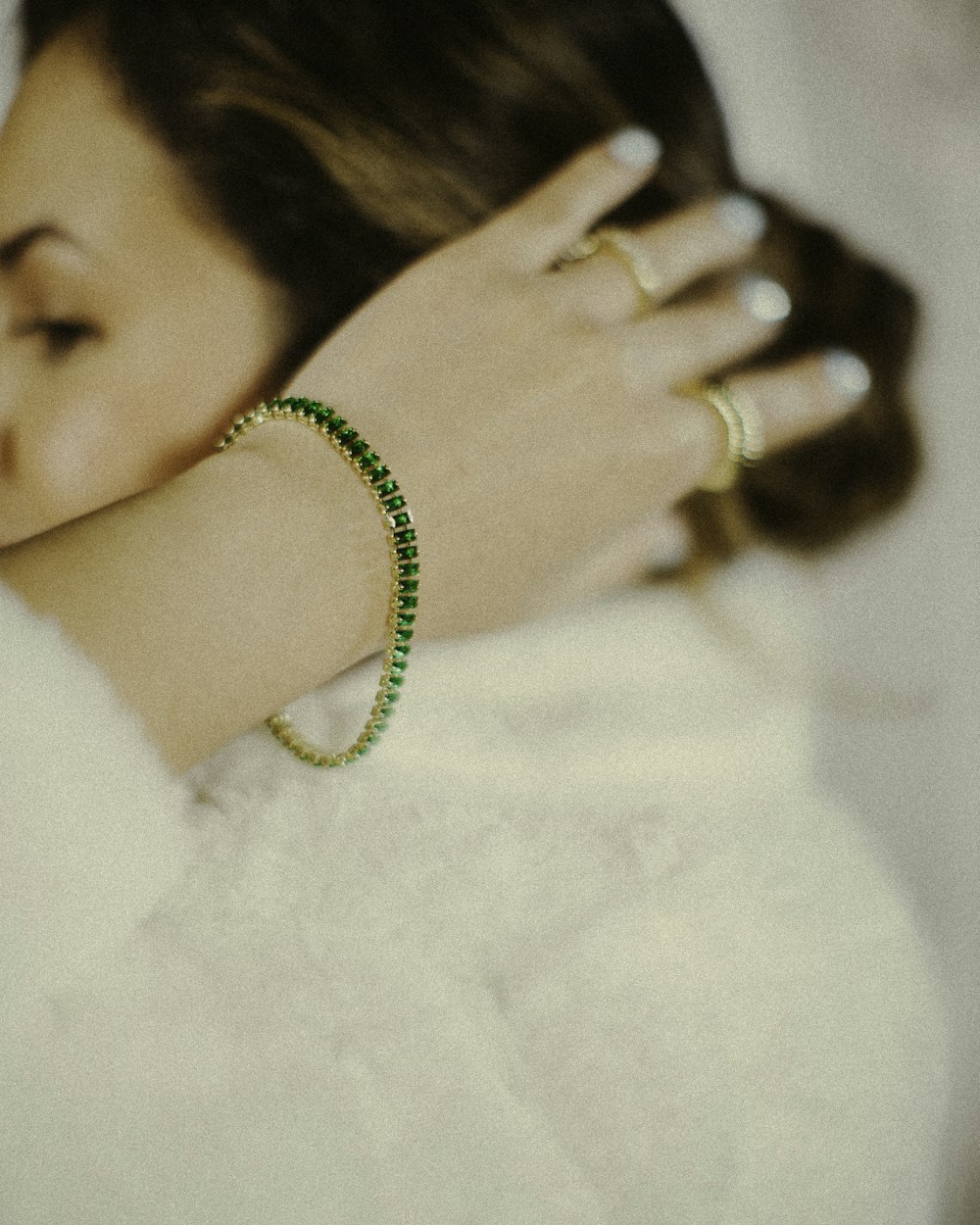a woman wearing a bracelet and a ring