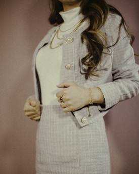 A stylish woman wearing a tailored jacket from the collection.