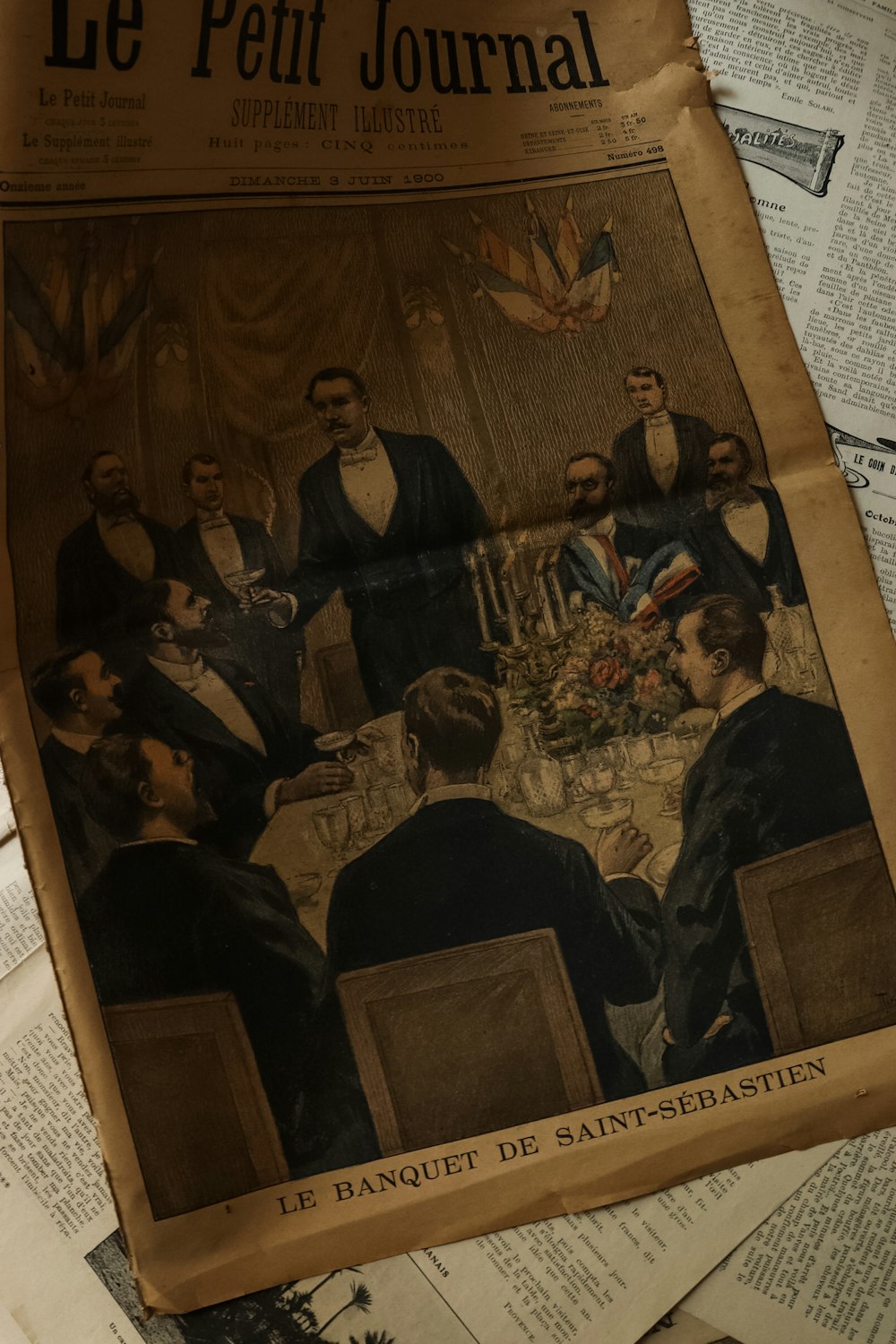 a newspaper with a picture of a group of people at a dinner table