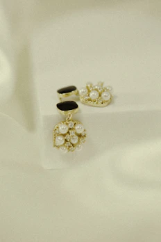 An elegant display of contemporary jewelry pieces featuring delicate gold and silver designs on a soft velvet background.