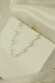 Elegant handmade necklaces displayed on a minimalist white background.