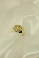 Close-up of delicate handmade lace jewelry resting on soft cream fabric with golden light.