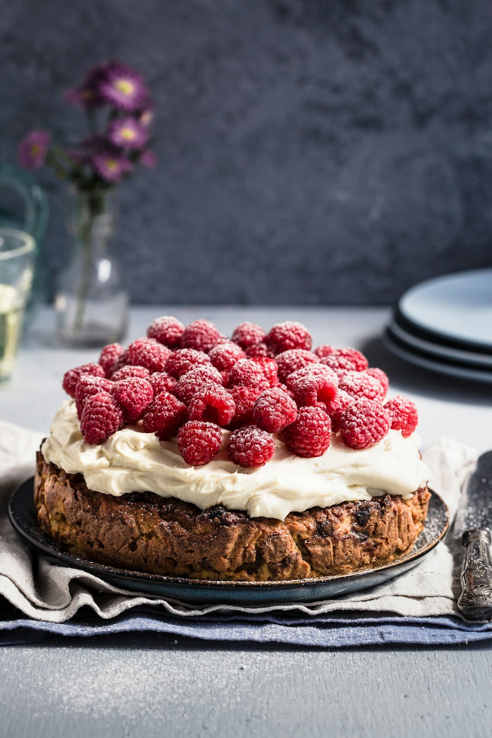 a cake with raspberries on top of it