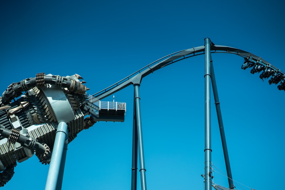 a roller coaster with a blue sky in the background