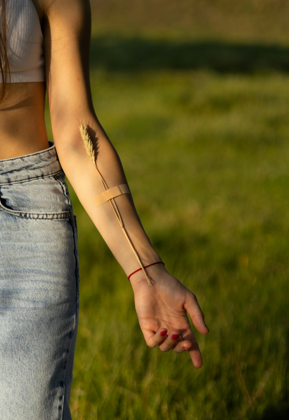 a woman with a tattoo on her arm holding a frisbee