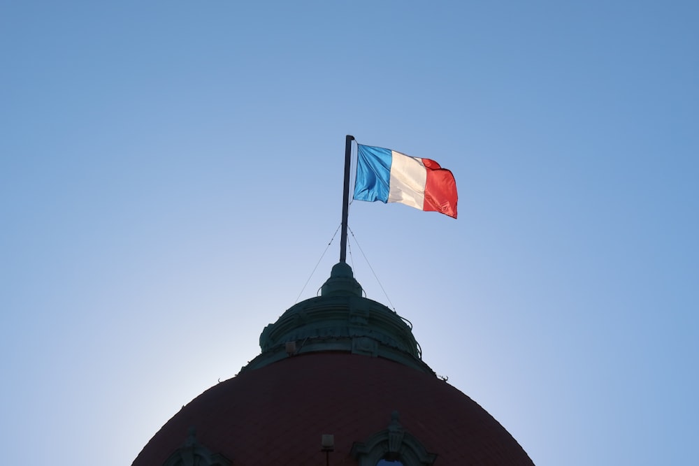 a flag flying on top of a building