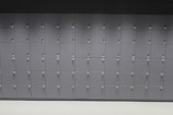 A wall consisting of multiple rows of grey lockers with sequential numbering on the doors. Each locker door has a keyhole, and the lockers are uniformly aligned.