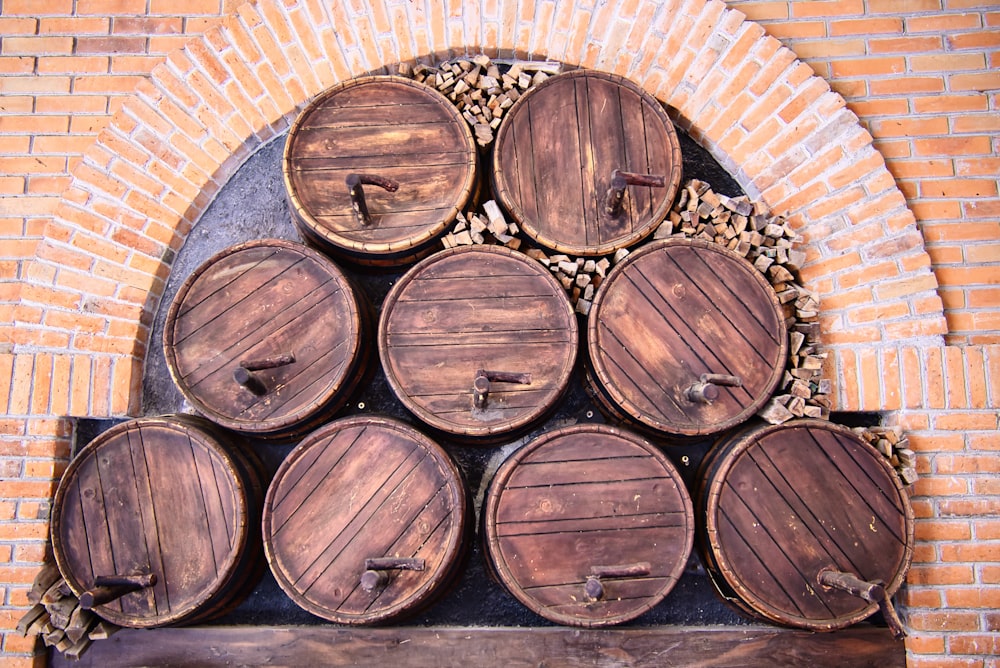 a bunch of wooden barrels stacked on top of each other