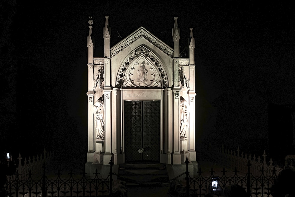 a church with a clock tower lit up at night