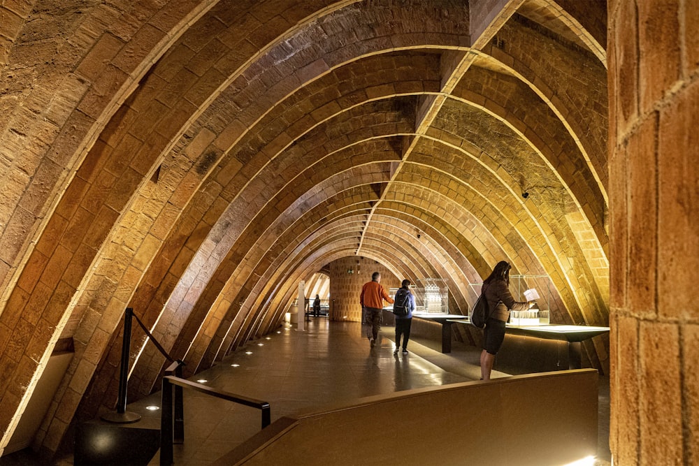 a group of people walking through a tunnel