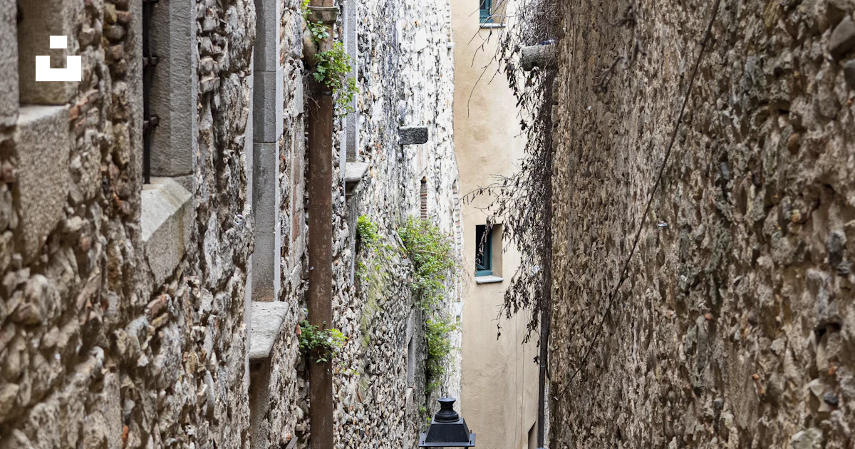 Une ruelle étroite avec des murs de pierre et des marches photo – Photo ...