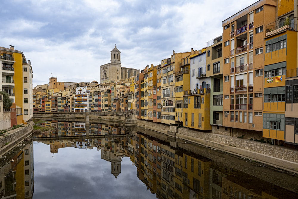 a river running through a city next to tall buildings