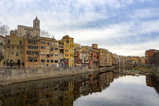 a river running through a city next to tall buildings