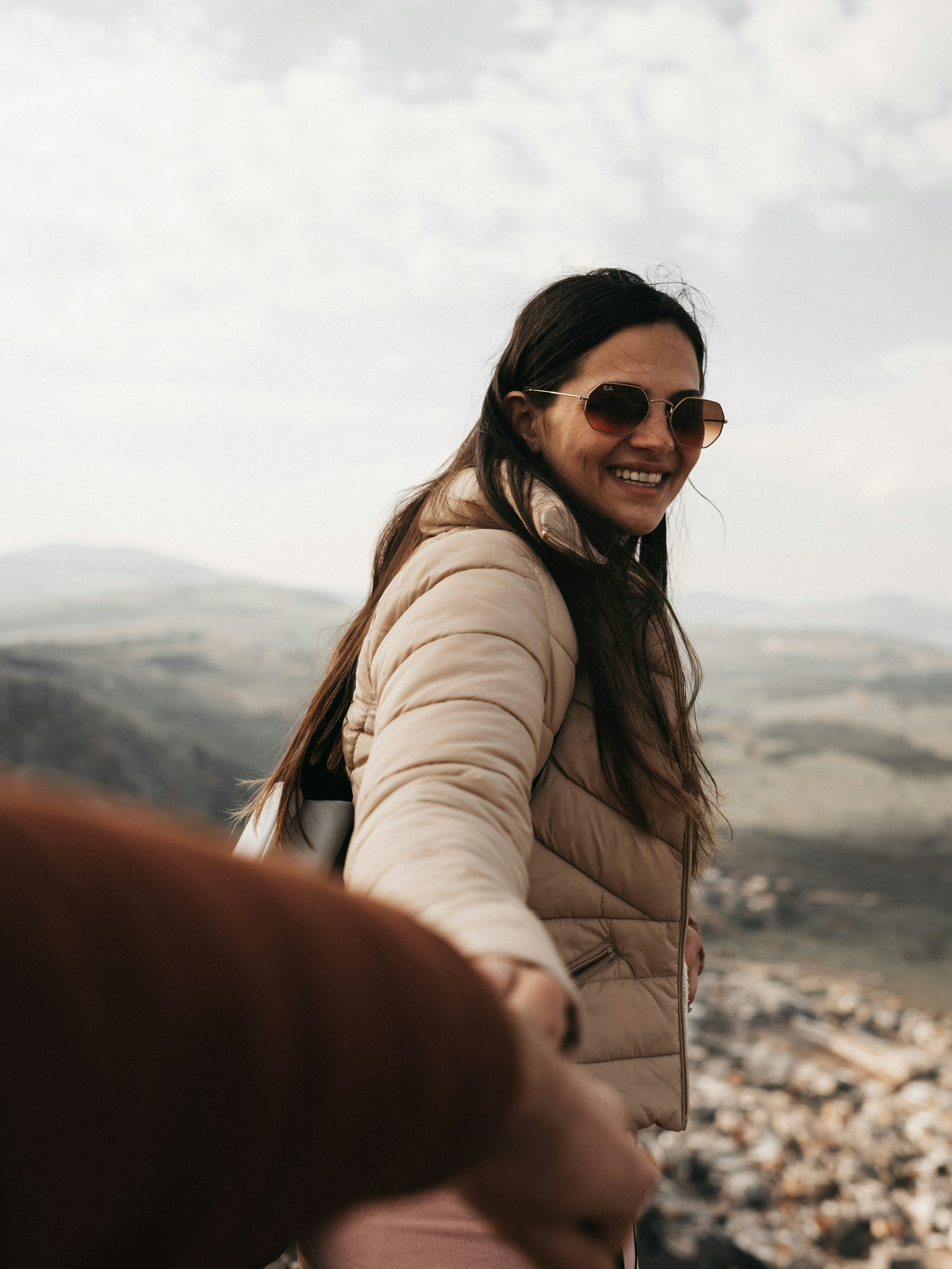 A woman is shaking hands with a man