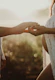 A serene scene of a couple holding hands surrounded by soft glowing light symbolizing love and connection.